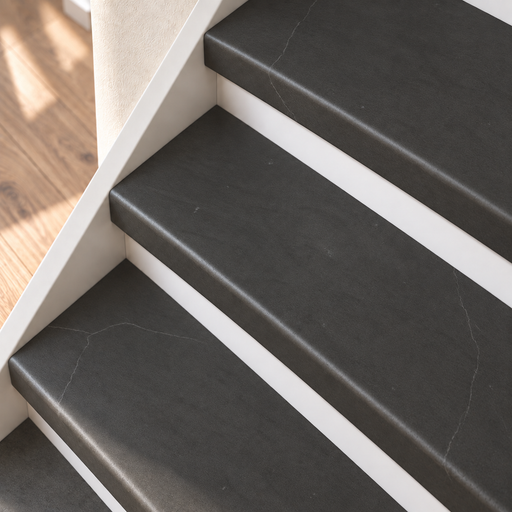 marmer traprenovatie, dichte trap met witte stootborden, detail schuin van boven